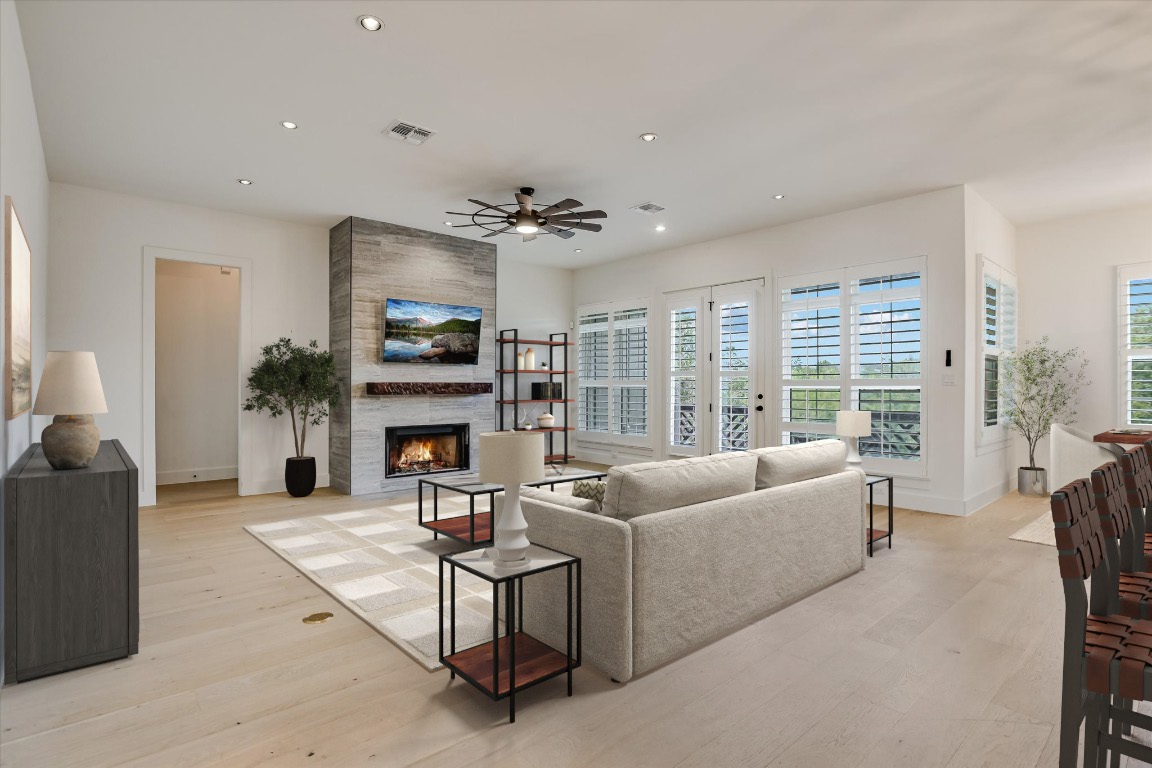 935 Wesley Ridge Drive Spicewood, TX 78669 - Photo 8 of 40 a living room with furniture a fireplace and a large window