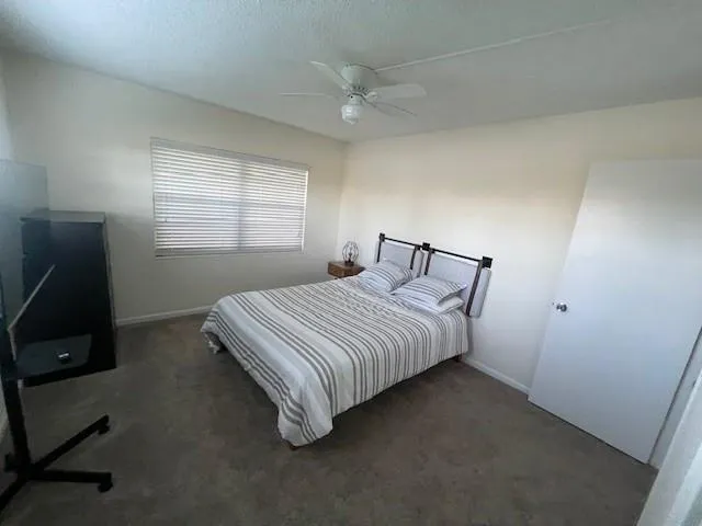 a spacious bedroom with a bed and a desk