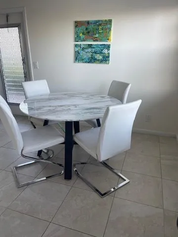 a view of a room with a table and chairs