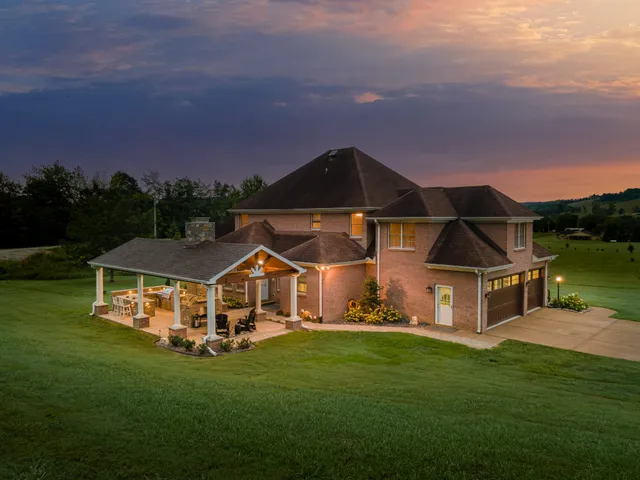 a front view of a house with a yard and potted plants