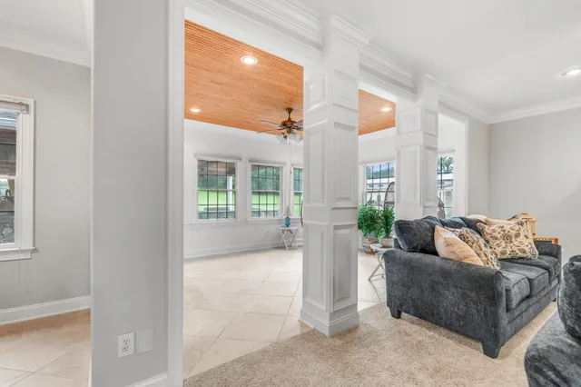 a view of a livingroom with furniture and a ceiling fan
