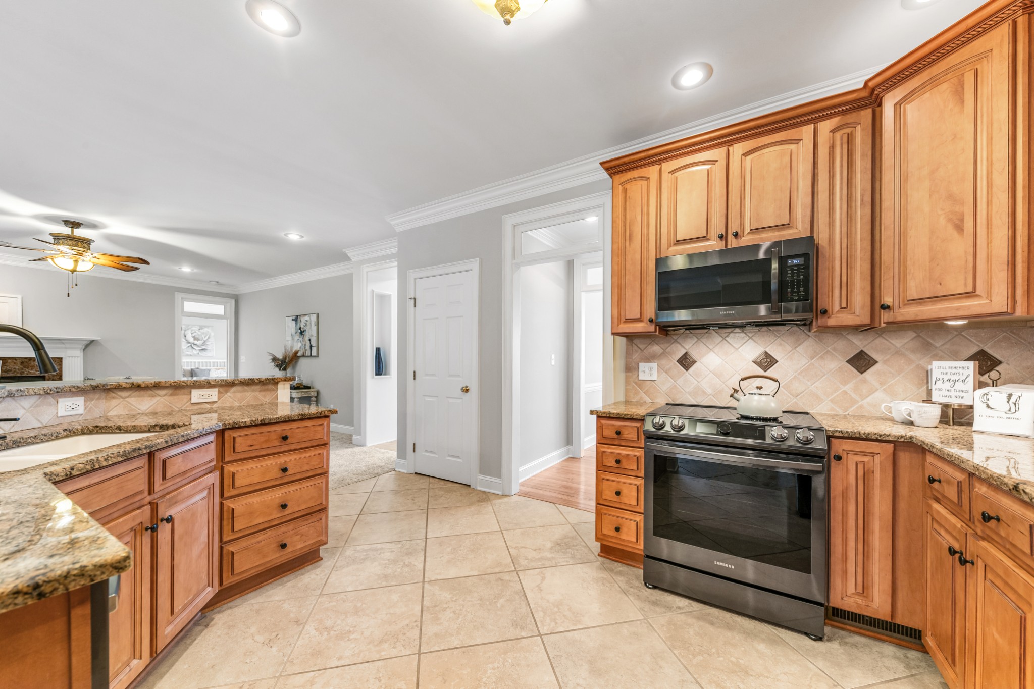 3895 Ostella Road Lewisburg, TN 37091 - Photo 22 of 100 a kitchen with stainless steel appliances granite countertop a stove a sink and a microwave