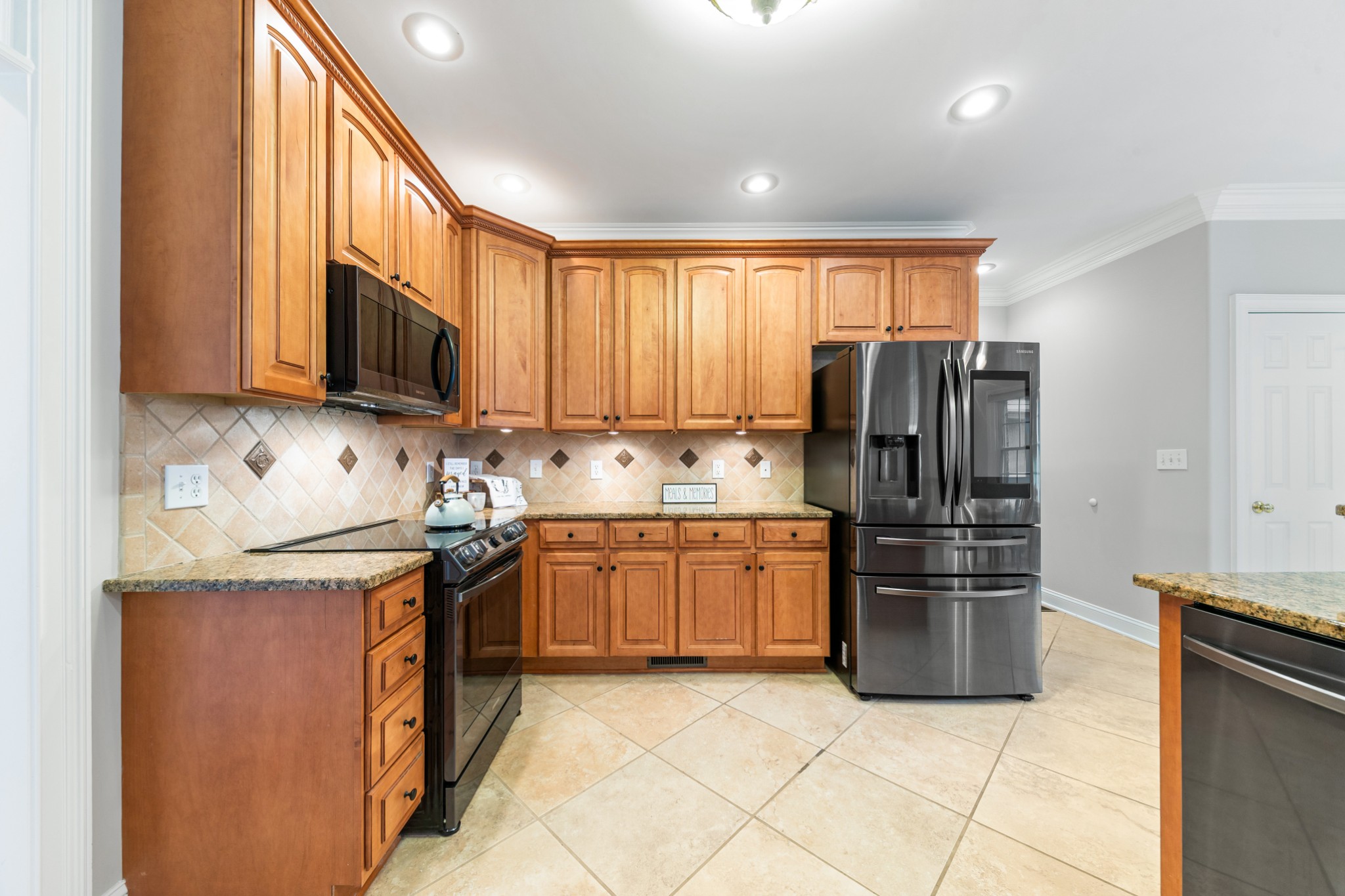 3895 Ostella Road Lewisburg, TN 37091 - Photo 24 of 100 a kitchen with granite countertop a refrigerator and a stove top oven