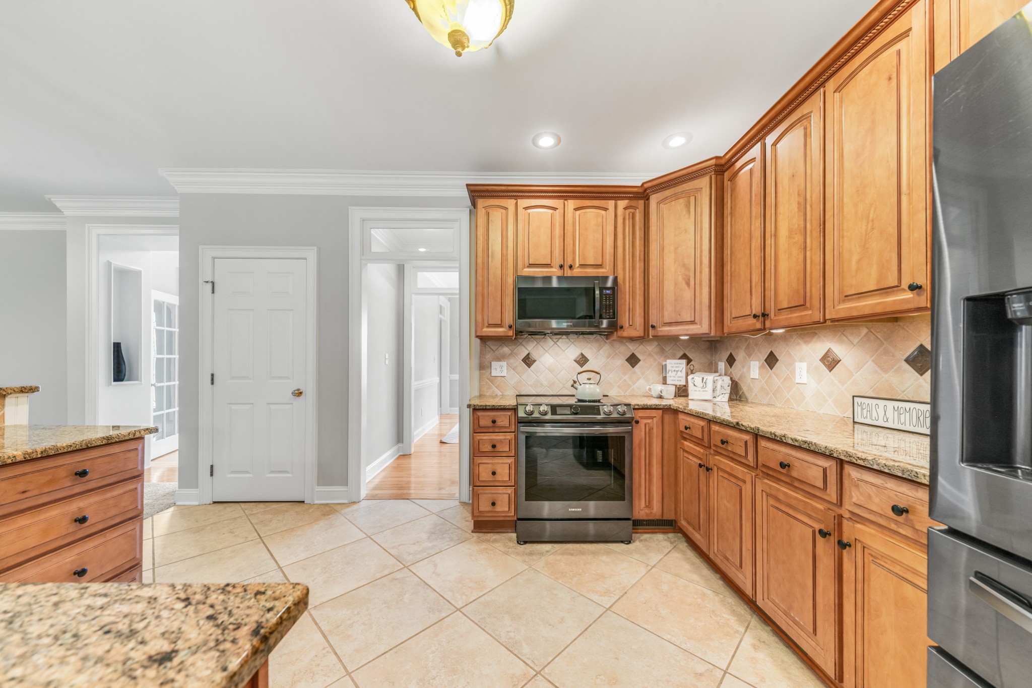 3895 Ostella Road Lewisburg, TN 37091 - Photo 26 of 100 a kitchen with stainless steel appliances granite countertop a stove top oven a sink dishwasher and a refrigerator with wooden cabinets