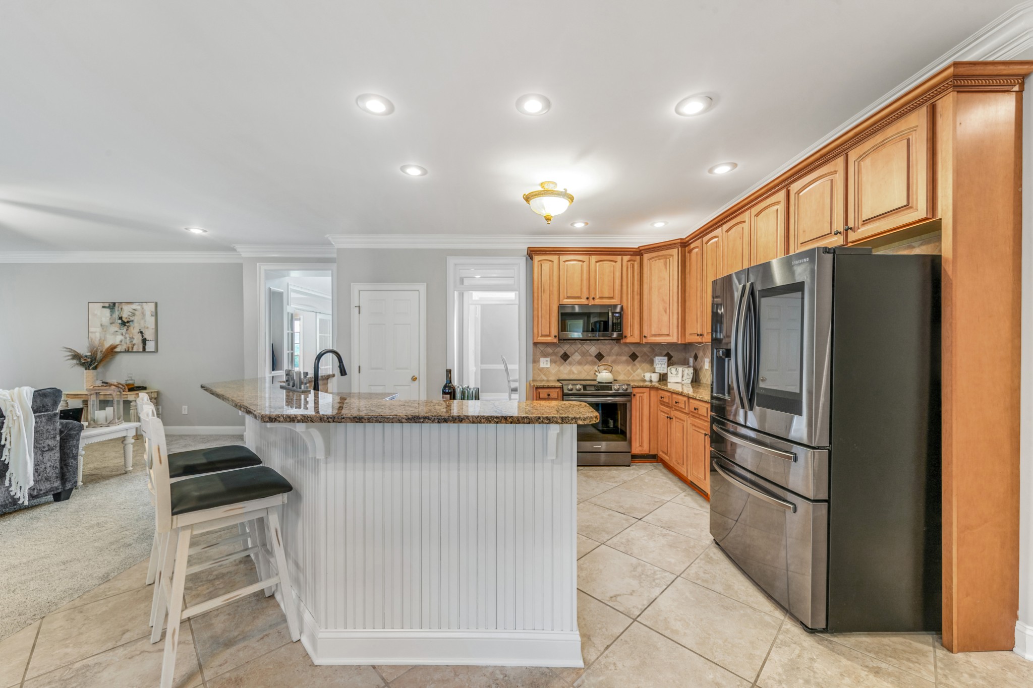 3895 Ostella Road Lewisburg, TN 37091 - Photo 28 of 100 a kitchen with stainless steel appliances granite countertop a sink refrigerator and cabinets