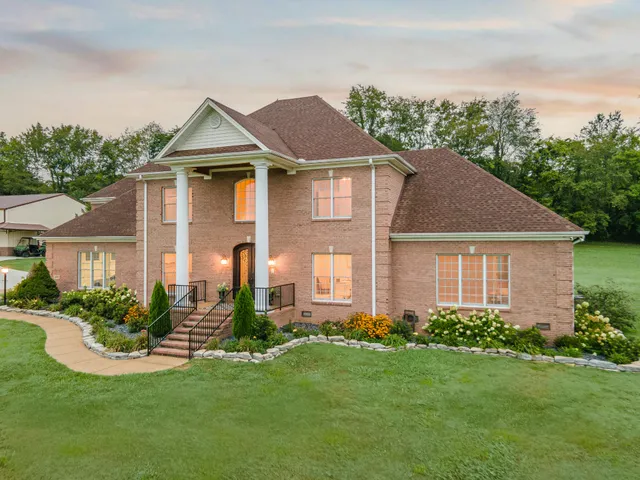 a view of a hallway with wooden floor and windows