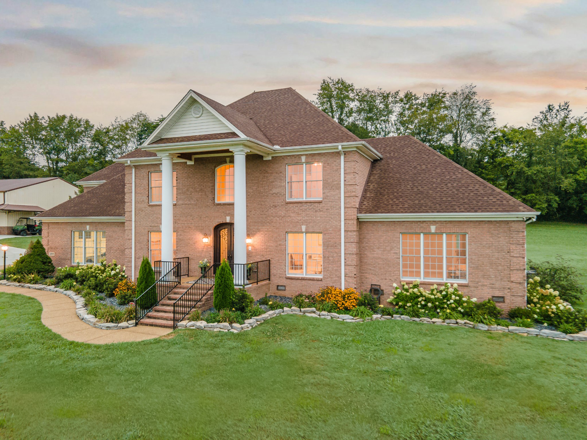 3895 Ostella Road Lewisburg, TN 37091 - Photo 6 of 100 a front view of a house with a yard and potted plants