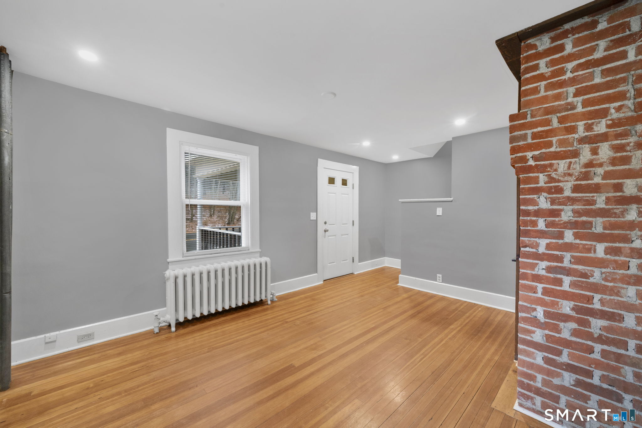 37 Bushy Hill Road Simsbury, CT 06070 - Photo 9 of 23 a view of an empty room with wooden floor and a window