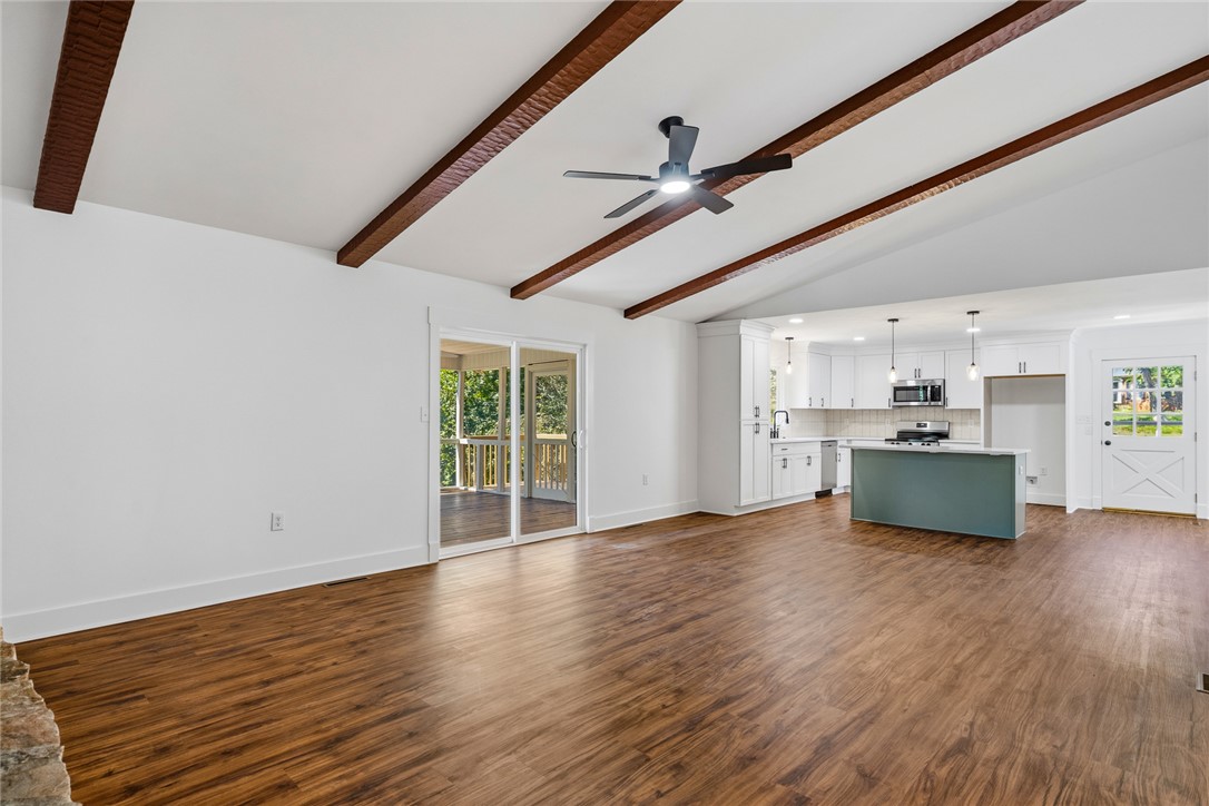 208 Williamsburg Road Anderson, SC 29621 - Photo 14 of 48 Gleaming wood floors anchor a seamless transition from the vaulted living room to the kitchen.
