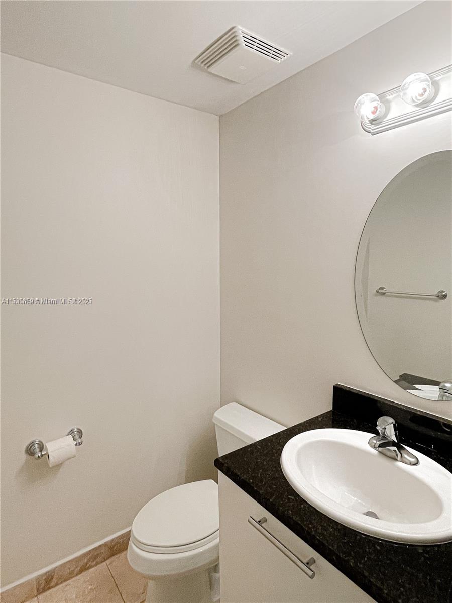 3339 Virginia Street, Unit PH26 Miami, FL 33133 - Photo 11 of 19 a bathroom with a sink a toilet and mirror