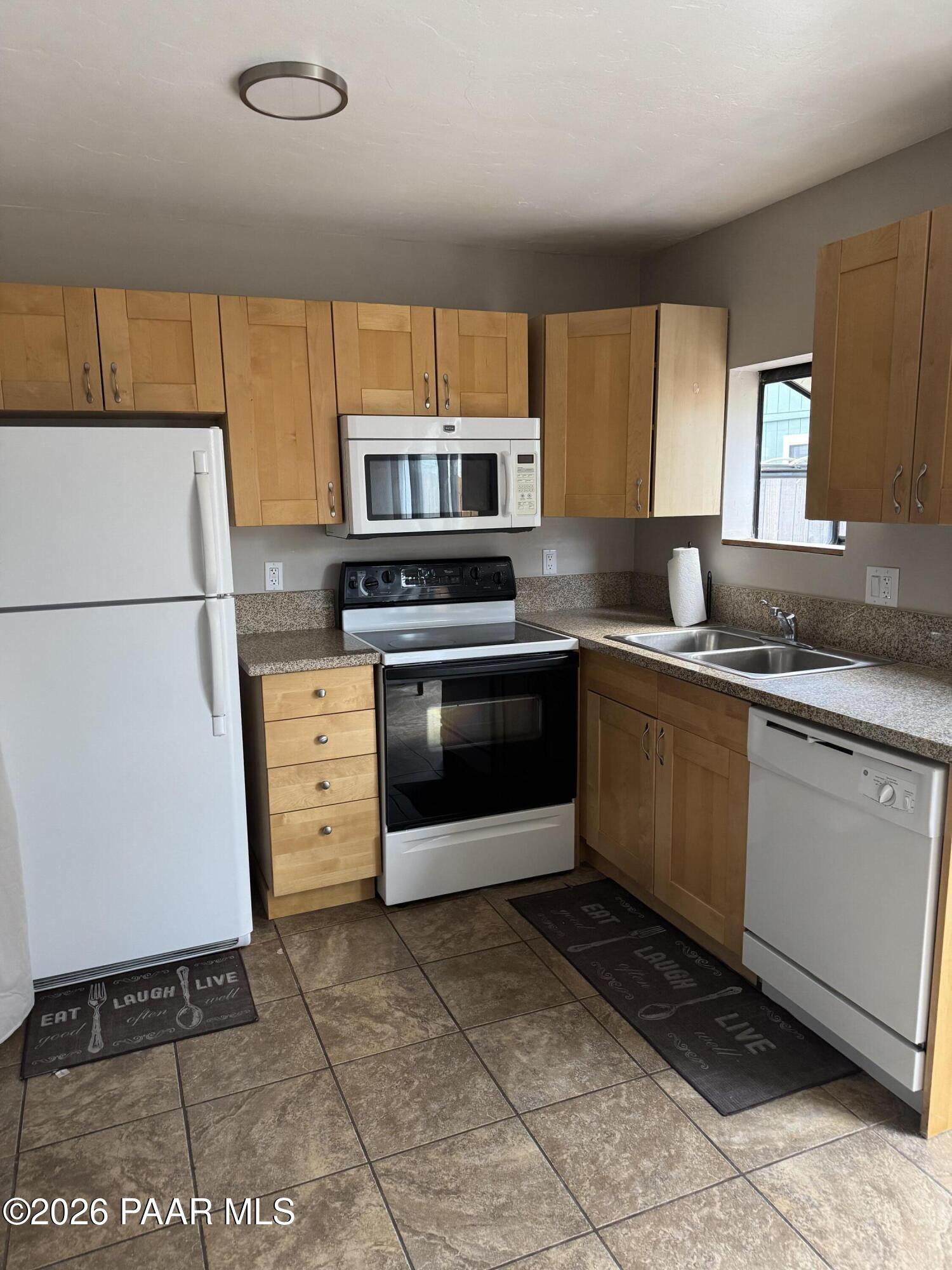 845 Sunset Avenue, Unit D Prescott, AZ 86305 - Photo 6 of 10 a kitchen with stainless steel appliances granite countertop a stove a sink and a refrigerator