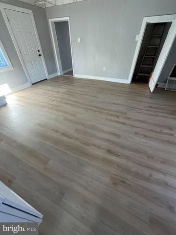 a view of a room with wooden floor