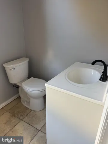 a white toilet sitting next to a white sink