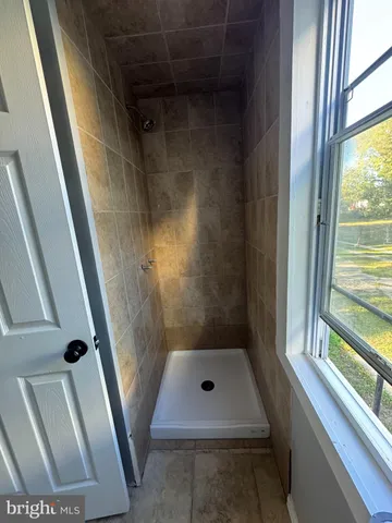 a bathroom with a sink a toilet and a shower