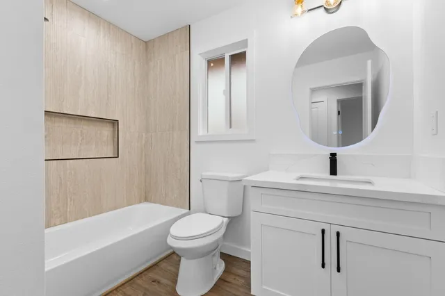 a bathroom with a toilet a sink and bathtub