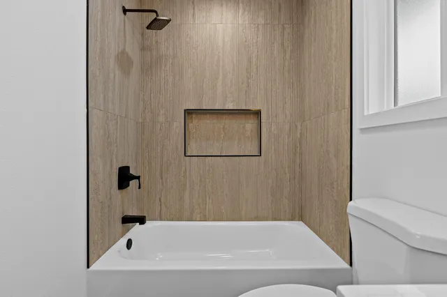 a bathroom with a bathtub and shower