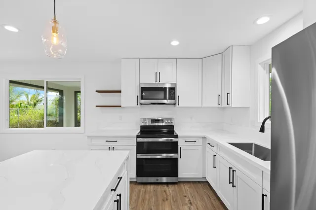 a kitchen with a sink a stove and refrigerator