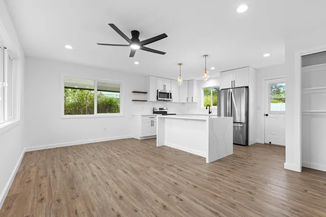 a view of a kitchen with a sink and a window