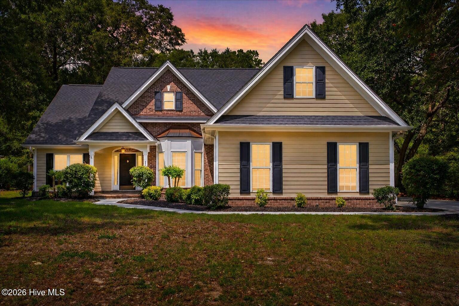 8985 Woodbine Road Southwest Sunset Beach, NC 28468 - Photo 2 of 65 Twilight photo of the front exterior.
