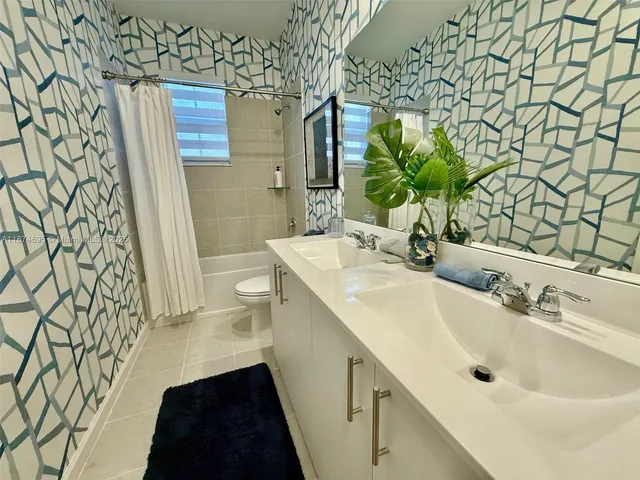 a view of a street with palm trees