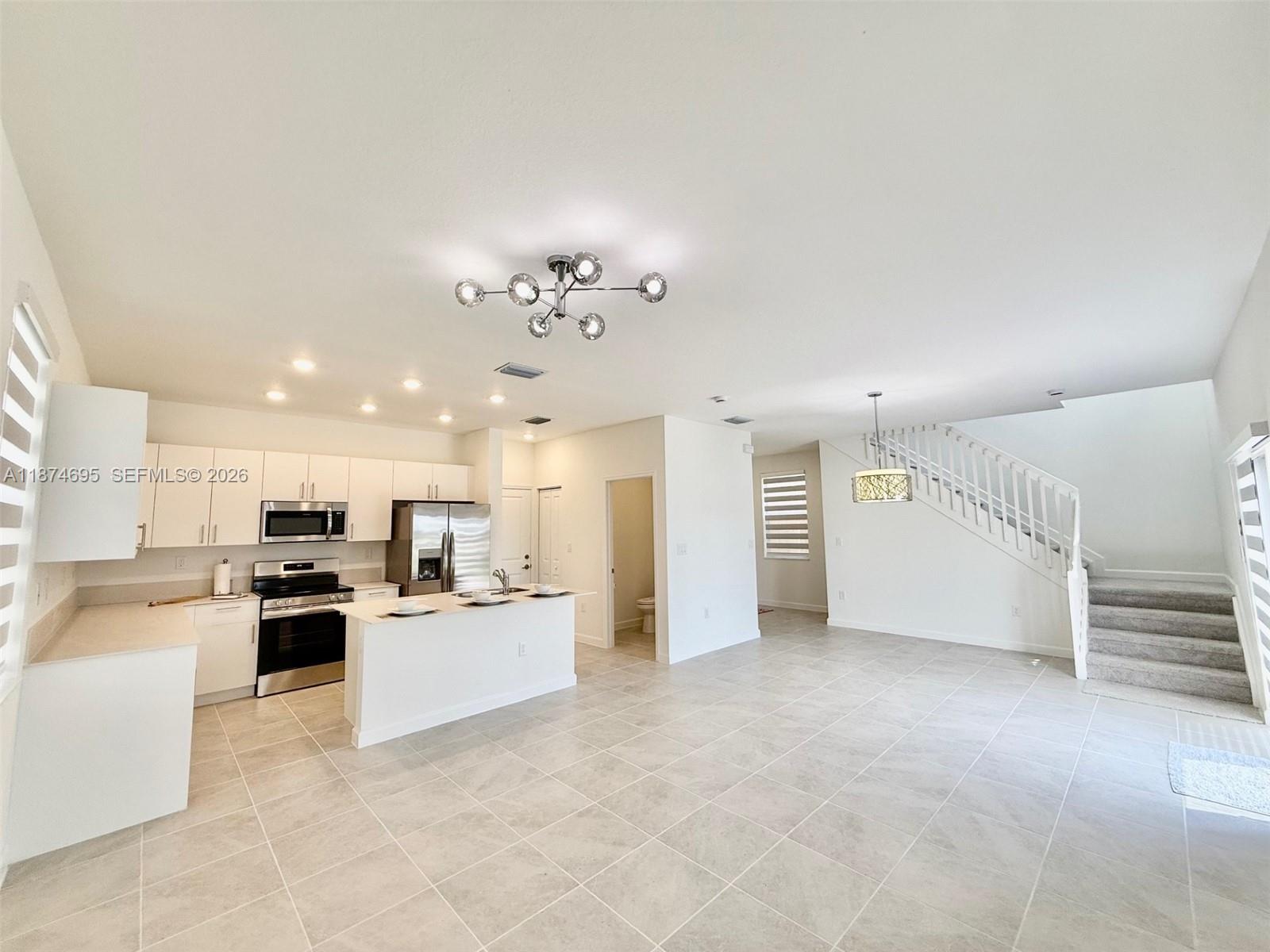 2600 Southeast 25th Street Homestead, FL 33035 - Photo 21 of 61 a large kitchen with cabinets and stainless steel appliances