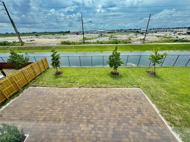 a view of a kitchen with flat screen tv and refrigerator
