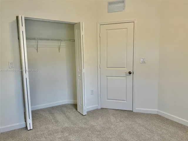 a view of a bathroom with white door