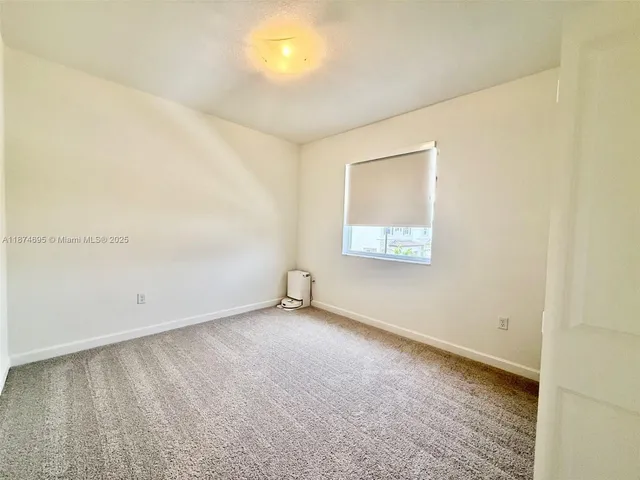 an aerial view of multiple houses with a yard