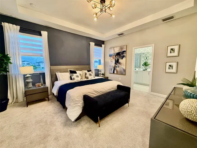 a bedroom with a bed couch and window