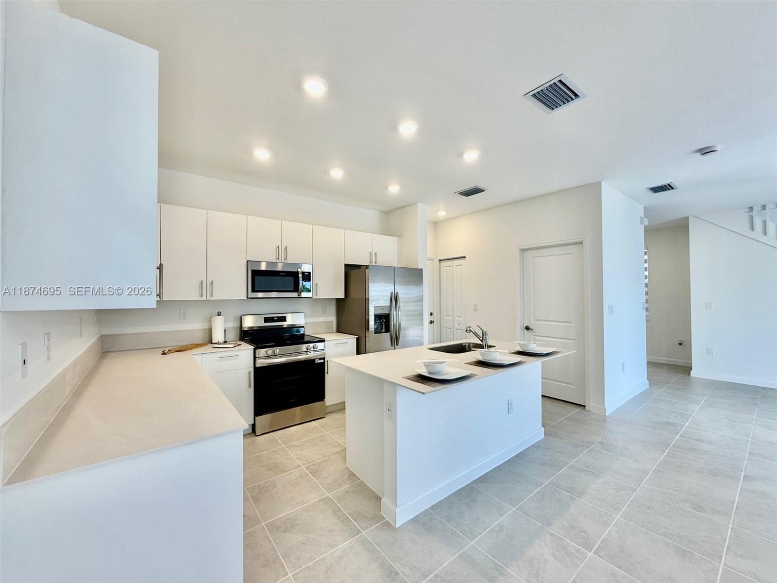 2600 Southeast 25th Street Homestead, FL 33035 - Photo 6 of 61 a kitchen with stainless steel appliances granite countertop a sink stove and refrigerator