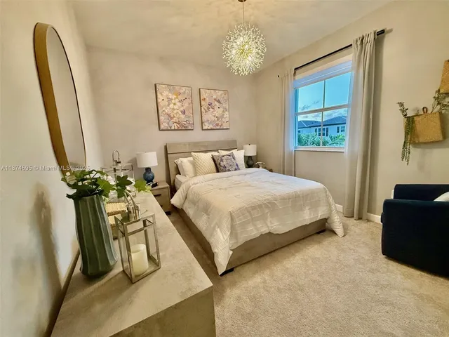 a living room with furniture and a baby crib