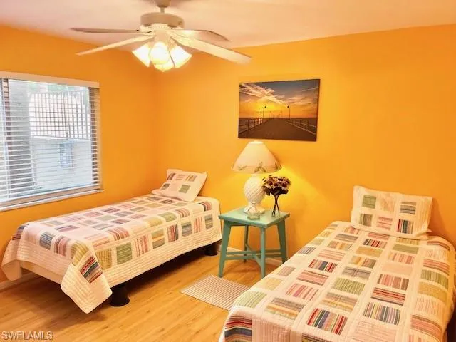 a bedroom with a bed lamps and window