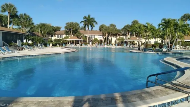 a view of swimming pool with outdoor seating and lake view