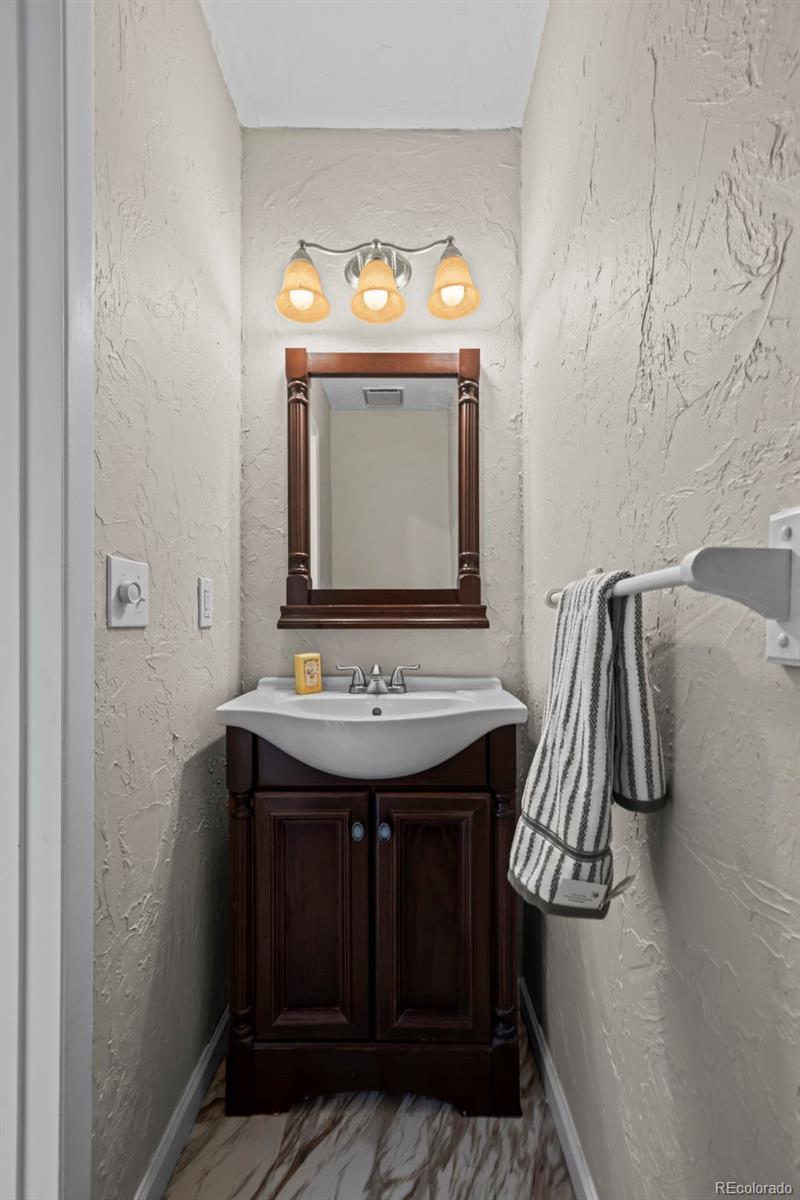 10721 Queen Street Broomfield, CO 80021 - Photo 12 of 25 a view of a bathroom with a sink and mirror
