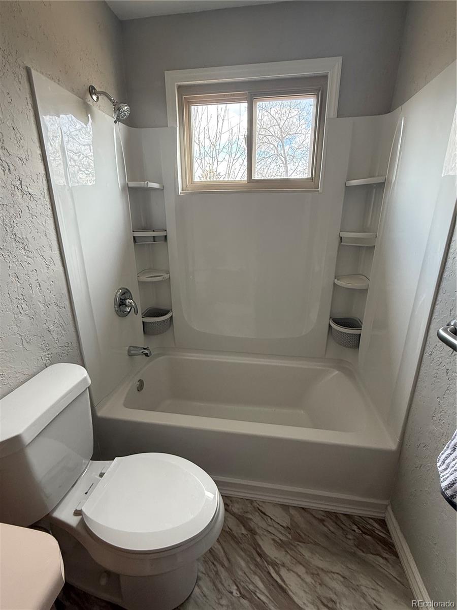 10721 Queen Street Broomfield, CO 80021 - Photo 14 of 25 a bathroom with a toilet and a shower