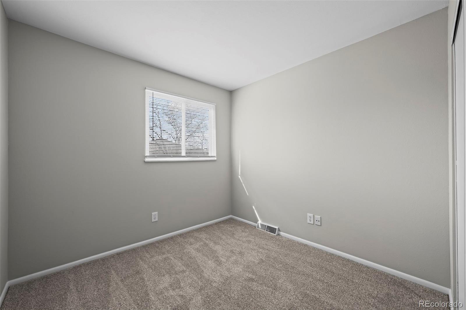 10721 Queen Street Broomfield, CO 80021 - Photo 16 of 25 an empty room with a window