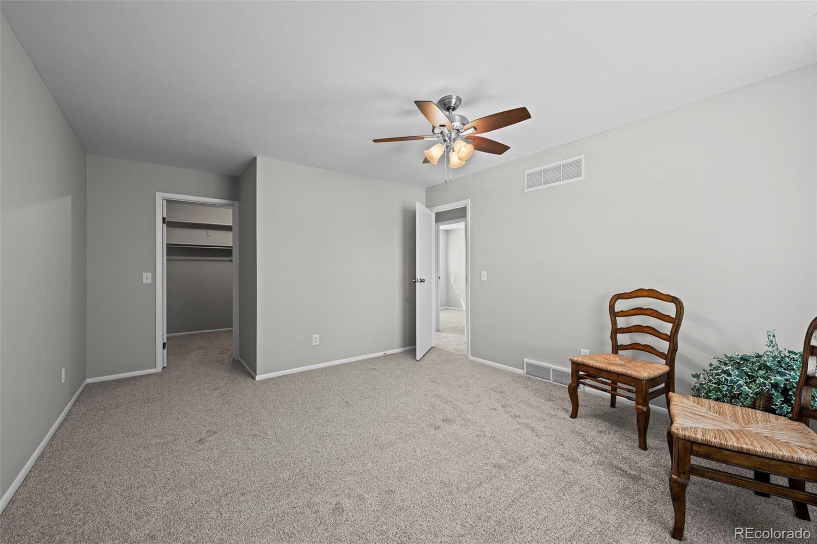 10721 Queen Street Broomfield, CO 80021 - Photo 18 of 25 a view of a livingroom with furniture and a ceiling fan