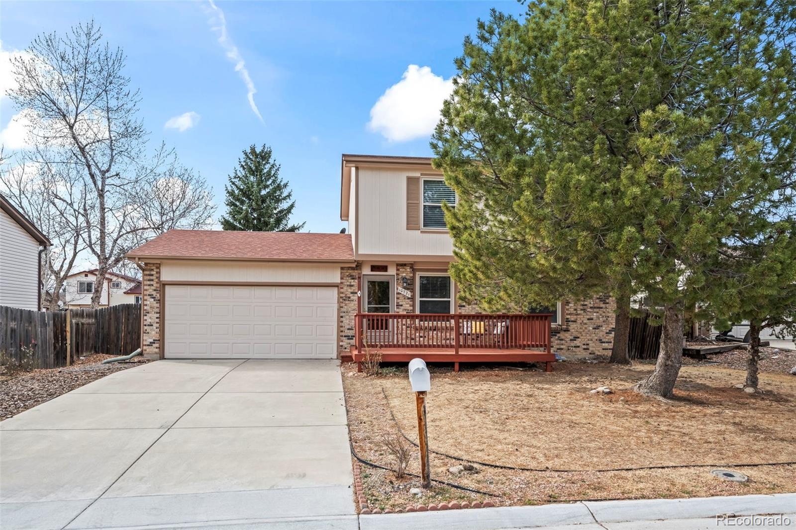 10721 Queen Street Broomfield, CO 80021 - Photo 2 of 25 a view of a house with a yard