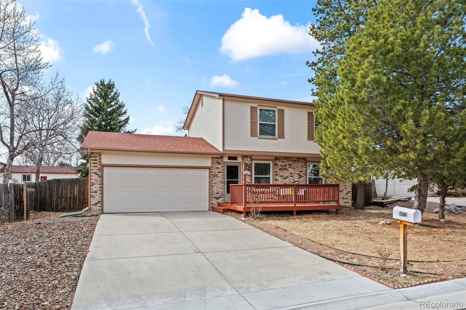 10721 Queen Street Broomfield, CO 80021 - Photo 25 of 25 a front view of a house with a garden