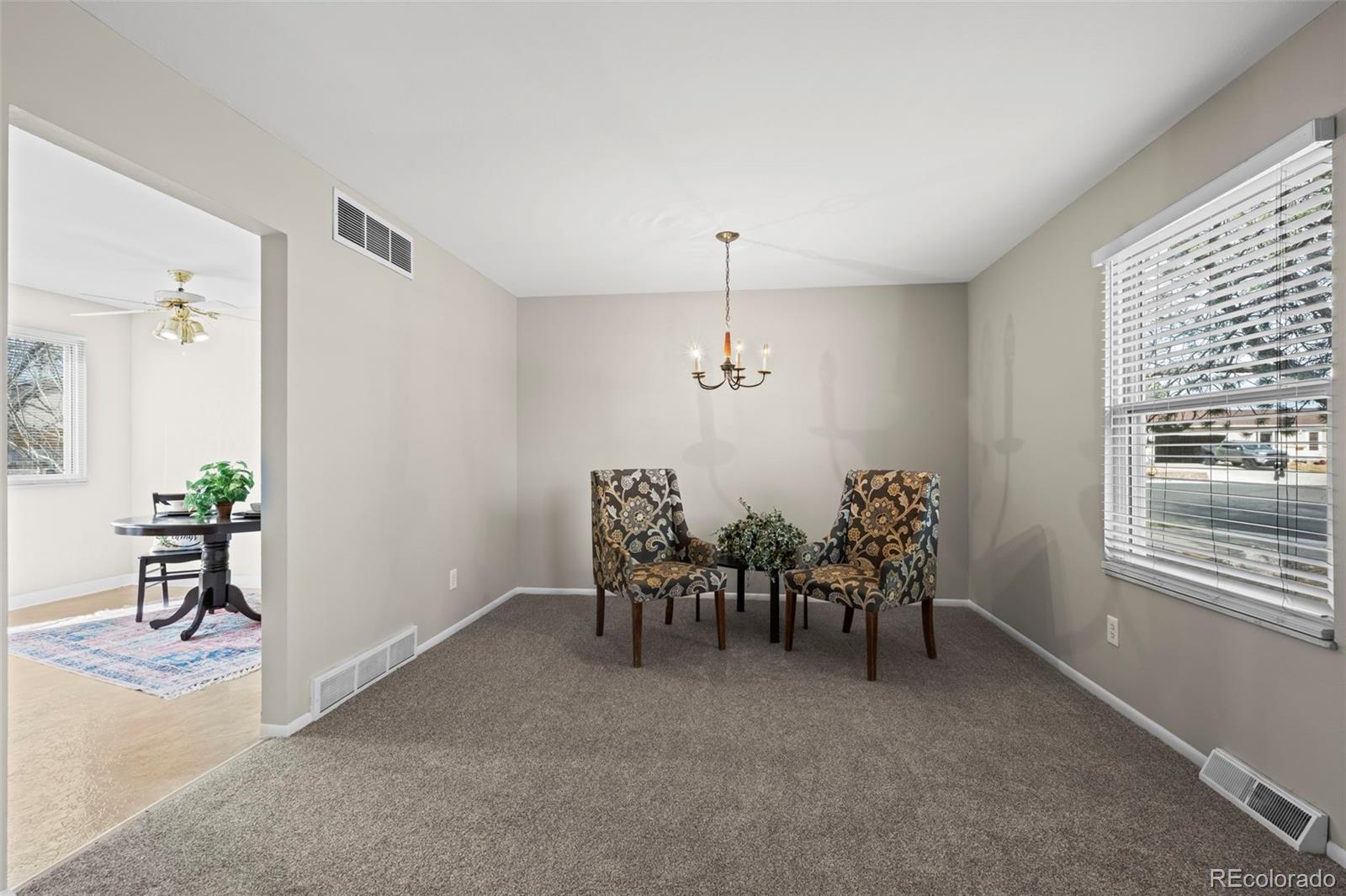 10721 Queen Street Broomfield, CO 80021 - Photo 5 of 25 a view of a livingroom with furniture window and wooden floor