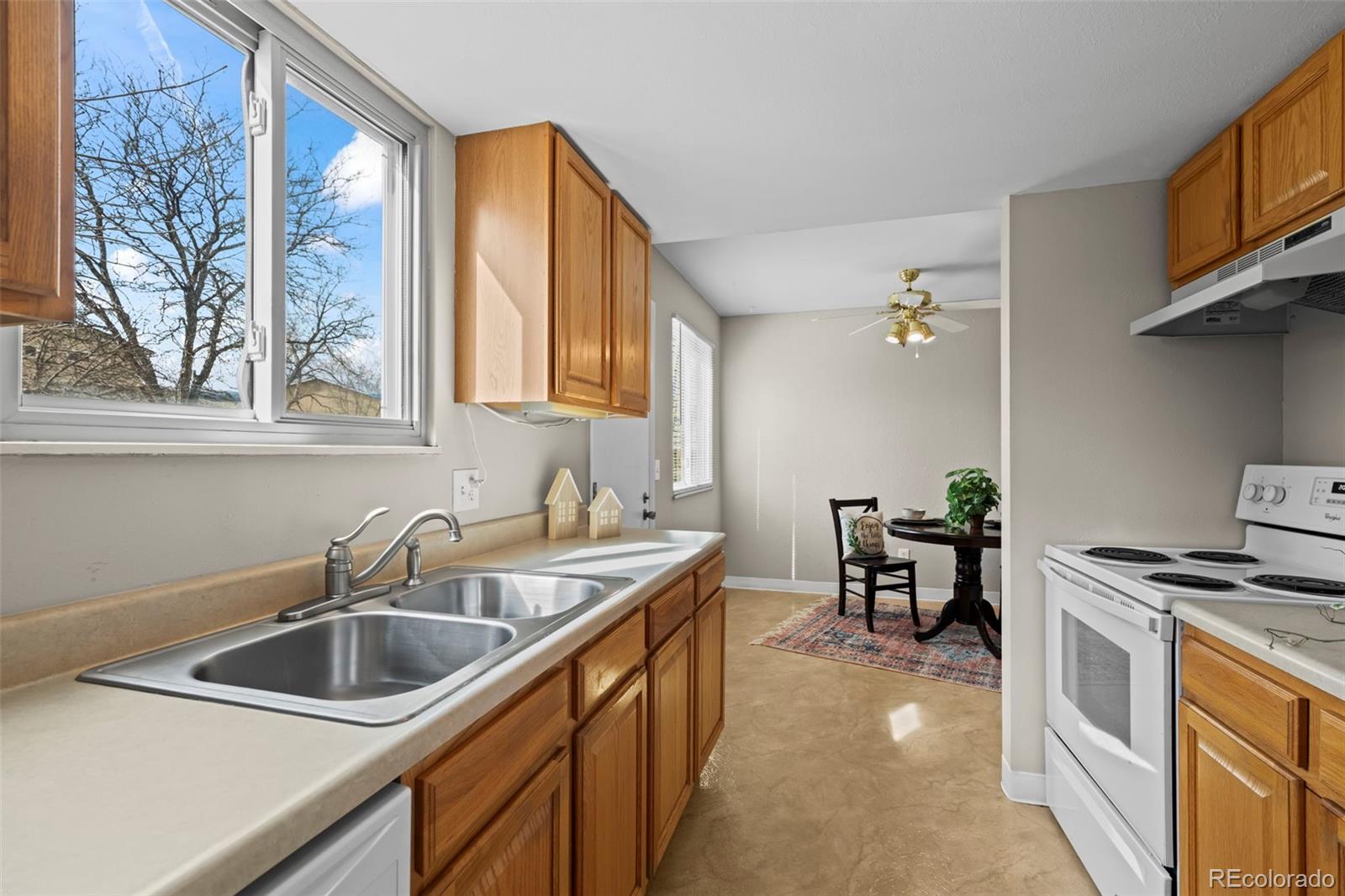 10721 Queen Street Broomfield, CO 80021 - Photo 9 of 25 a kitchen that has a sink and a stove