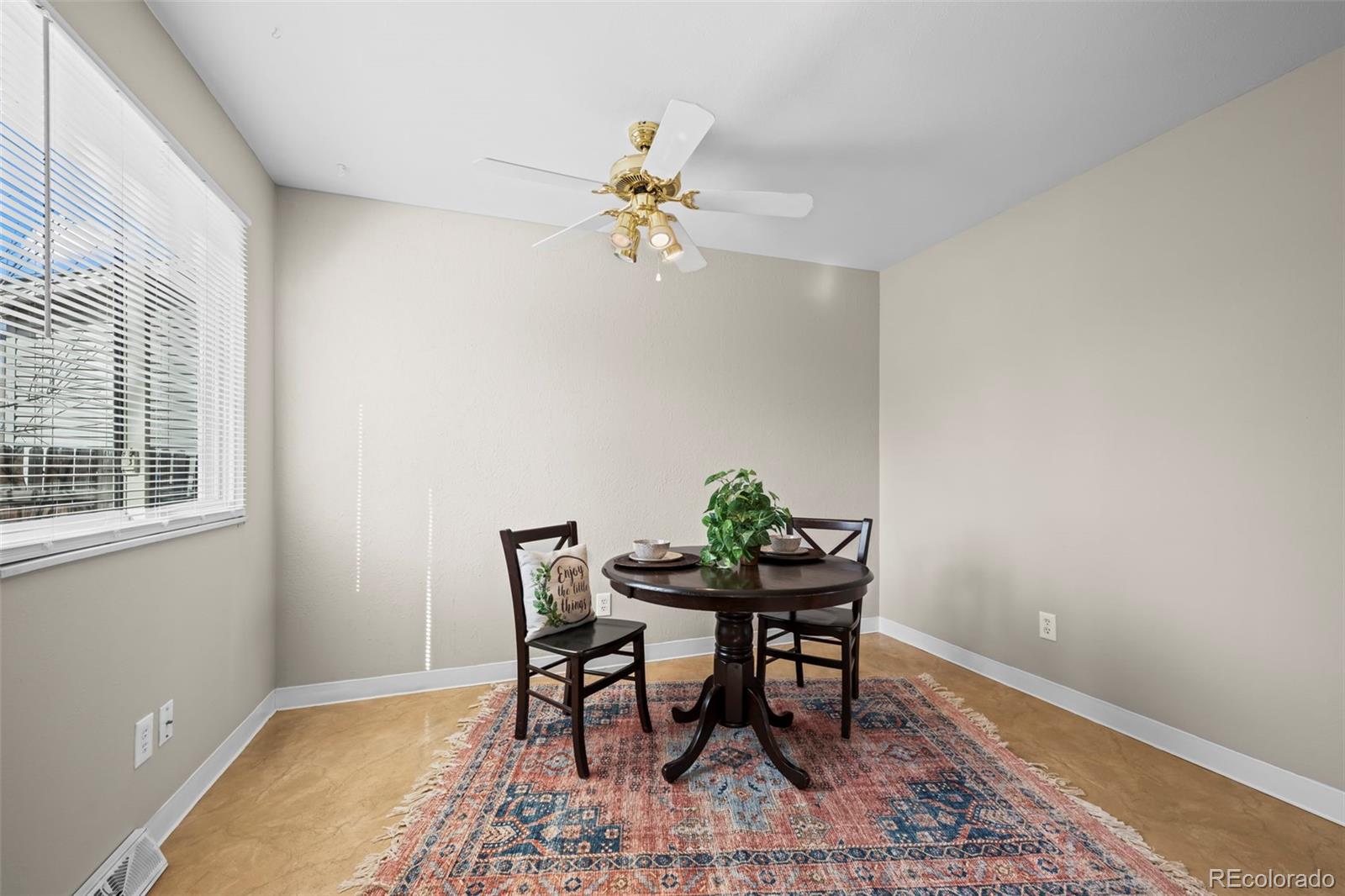 10721 Queen Street Broomfield, CO 80021 - Photo 10 of 25 a view of a dining room with furniture and wooden floor