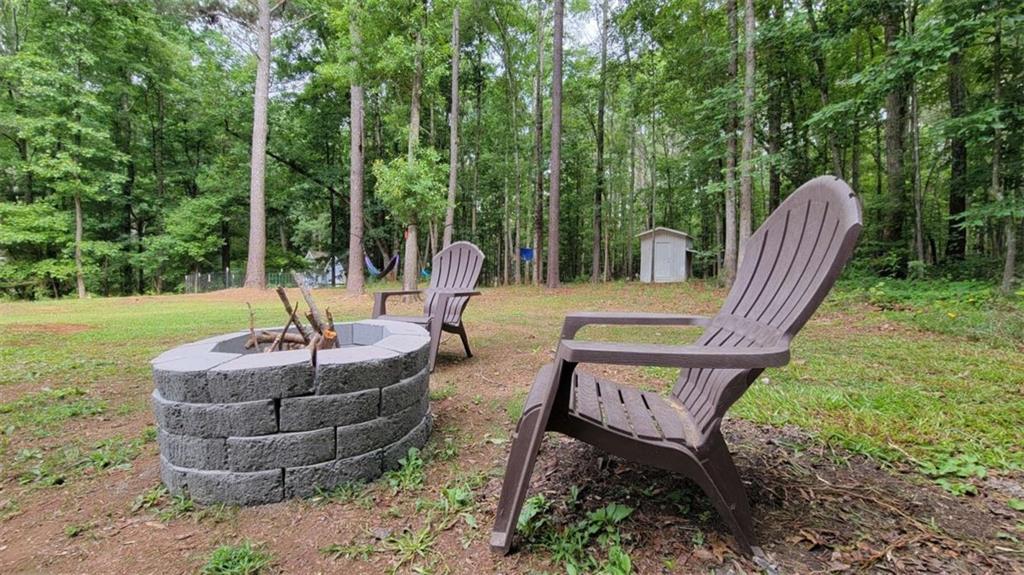 2140 Summerset Drive Monroe, GA 30656 - Photo 39 of 43 a view of a patio with table and chairs potted plants with large tree
