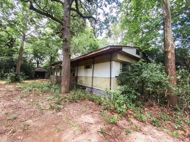 a backyard of a house with yard and garage