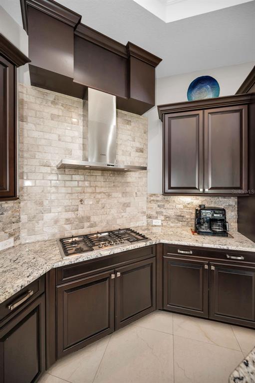 9829 Milano Drive Trinity, FL 34655 - Photo 22 of 100 a kitchen with stainless steel appliances granite countertop a sink stove and cabinets