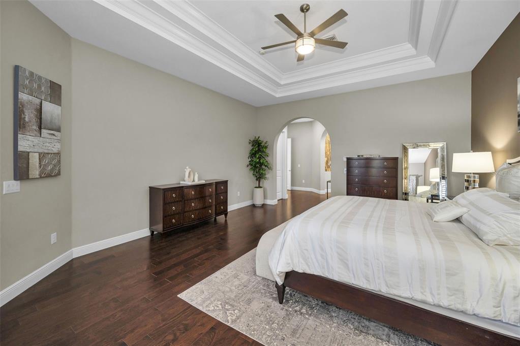 9829 Milano Drive Trinity, FL 34655 - Photo 42 of 100 a bedroom with a bed and wooden floor