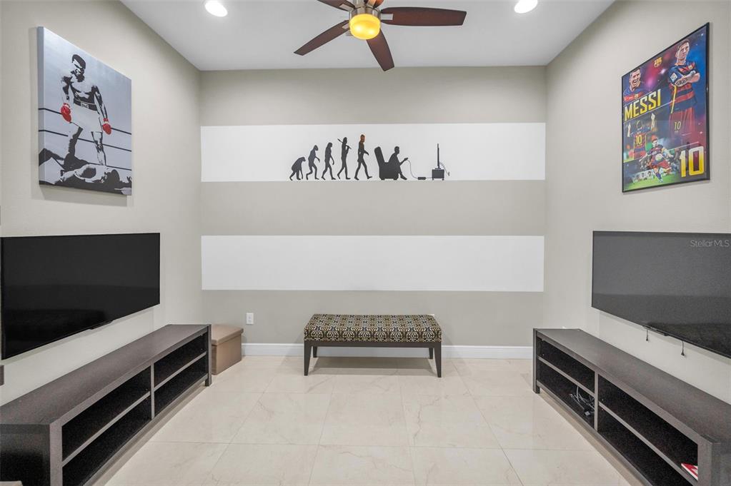 9829 Milano Drive Trinity, FL 34655 - Photo 57 of 100 a living room with furniture and a flat screen tv