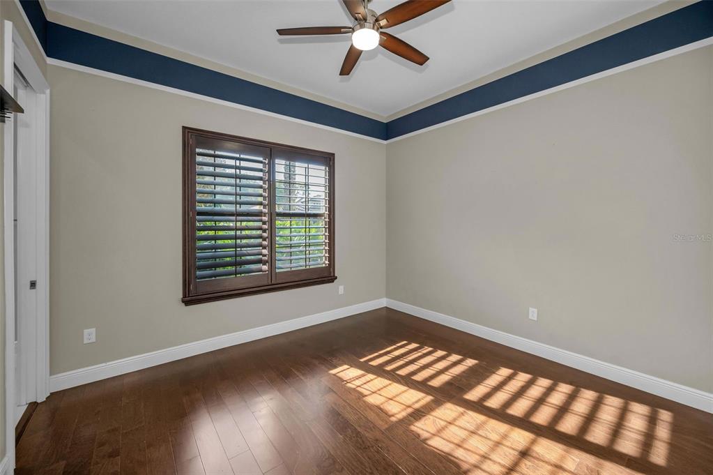 9829 Milano Drive Trinity, FL 34655 - Photo 60 of 100 a view of an empty room with window and wooden floor