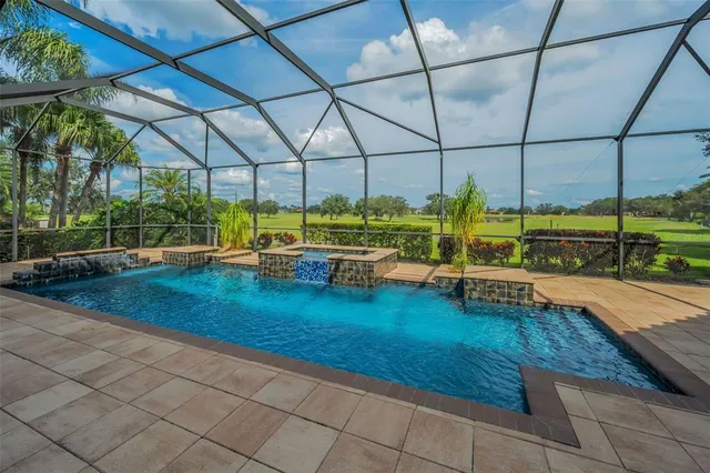 an aerial view of a house with a yard and lake view