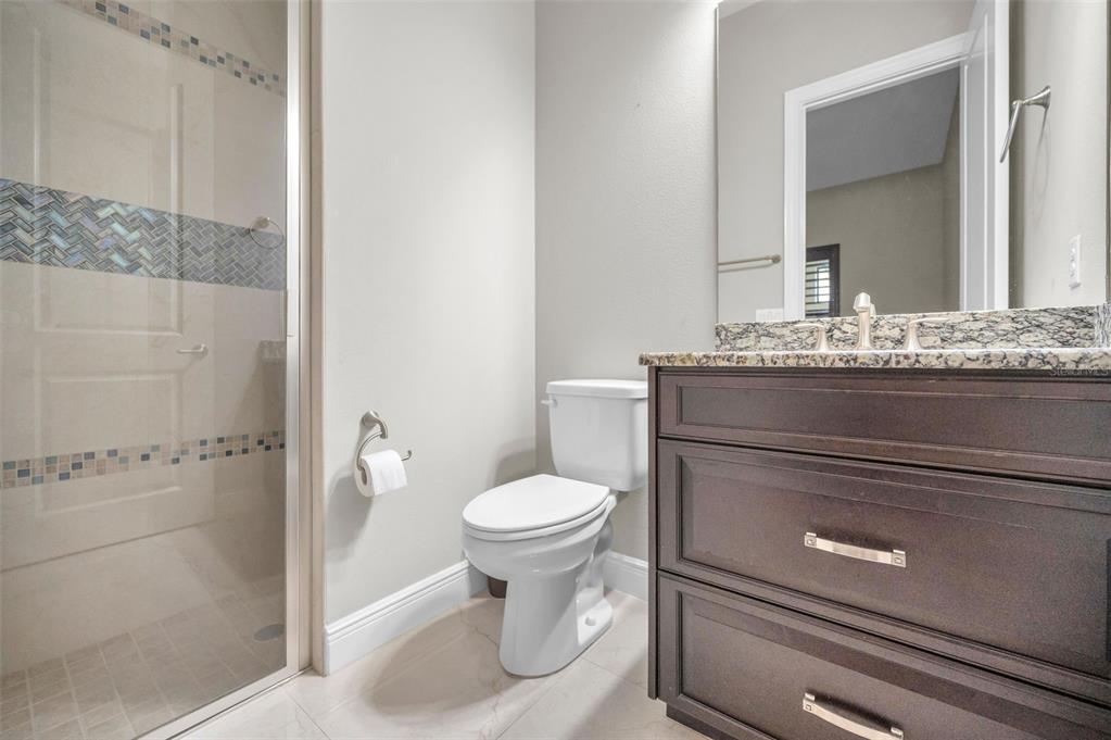 9829 Milano Drive Trinity, FL 34655 - Photo 64 of 100 a bathroom with a granite countertop toilet and a sink